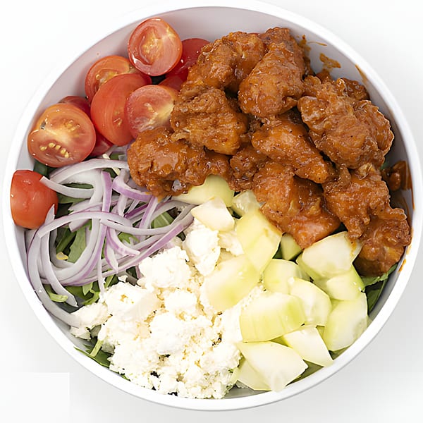 Holy Bowly's healthy bowl with buffalo chicken, tomatoes, red onions, feta, and cucumbers.